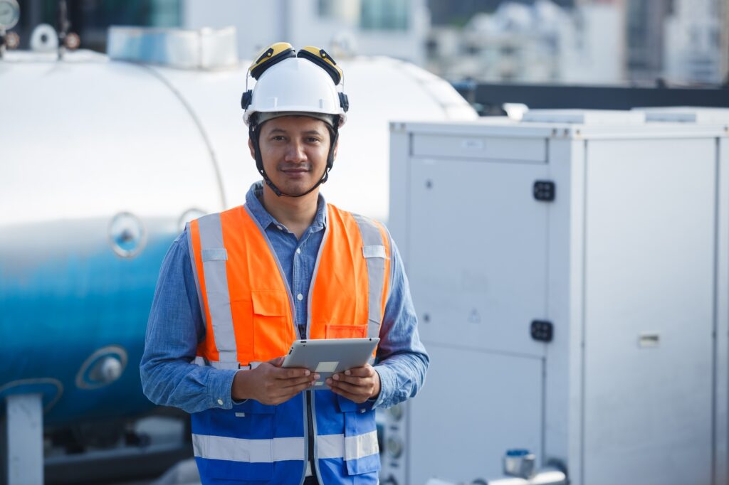 Male technician worker working checking hvac of office building.