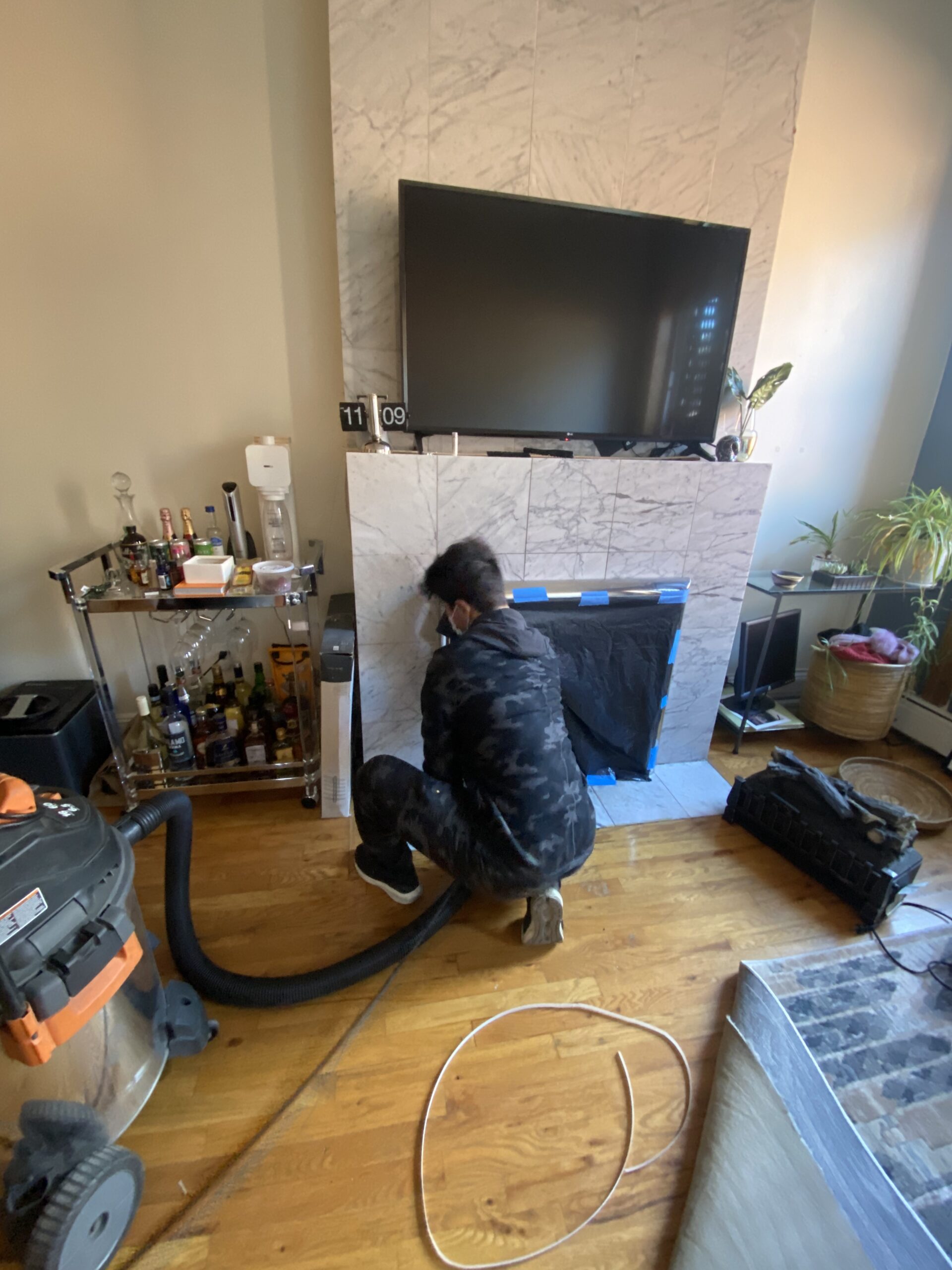 A technician is thoroughly cleaning the fireplace.