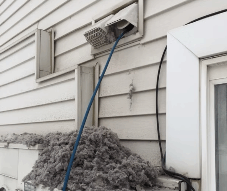 A technician uses specialized equipment to clean and clear a dryer vent, ensuring proper airflow and safety.